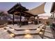 Well-equipped outdoor kitchen with pergola and seating at 19000 E Old Beau Trl, Queen Creek, AZ 85142