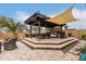 Outdoor kitchen with built-in grill, bar seating, and pergola at 19000 E Old Beau Trl, Queen Creek, AZ 85142