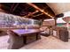 Large pergola with outdoor kitchen and dining area at 19000 E Old Beau Trl, Queen Creek, AZ 85142