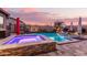 Sparkling pool and spa with stonework and lighting at 19000 E Old Beau Trl, Queen Creek, AZ 85142