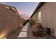Landscaped side yard with a stone pathway leading to a private gate at 19000 E Old Beau Trl, Queen Creek, AZ 85142