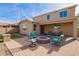 This backyard features a stone patio with a gas fire pit and comfortable seating at 2036 E Stacey Rd, Gilbert, AZ 85298