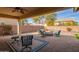 Outdoor patio with a fire pit, ample seating, and a ceiling fan for comfort at 2036 E Stacey Rd, Gilbert, AZ 85298