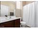 Well-lit bathroom featuring a vanity with solid surface countertops and a shower with a curtain at 2036 E Stacey Rd, Gilbert, AZ 85298