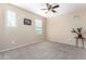 Bedroom with a plant stand, ceiling fan, and windows providing natural light at 2036 E Stacey Rd, Gilbert, AZ 85298