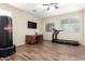 Versatile room with wood-look tile, ceiling fan and ample space, perfect for a home gym at 2036 E Stacey Rd, Gilbert, AZ 85298