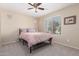 Bedroom with a metal bed frame, ceiling fan, and a view of the outdoors at 2036 E Stacey Rd, Gilbert, AZ 85298