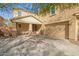Inviting two-story home with a large driveway, stylish front door, and covered porch with decorative stone pillars at 2036 E Stacey Rd, Gilbert, AZ 85298