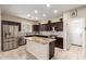Stylish kitchen with stainless steel appliances, dark wood cabinets, and an island with granite countertop at 2036 E Stacey Rd, Gilbert, AZ 85298