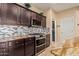 Gourmet kitchen featuring stainless steel appliances, granite countertops, and a custom backsplash at 2036 E Stacey Rd, Gilbert, AZ 85298