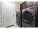 This laundry room features modern appliances, tile flooring, and direct access to the exterior at 2036 E Stacey Rd, Gilbert, AZ 85298