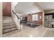 Open-concept space with tile flooring, staircase, and a seamless flow to the dining and kitchen areas at 2036 E Stacey Rd, Gilbert, AZ 85298