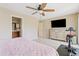 Main bedroom with ceiling fan, dresser and large TV at 2150 W Alameda Rd # 1313, Phoenix, AZ 85085