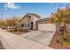 Modern single-story home with gray exterior, two-car garage, and landscaping at 2181 N 211Th Dr, Buckeye, AZ 85396