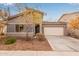 Single-story home with gray exterior, two-car garage, and landscaping at 2181 N 211Th Dr, Buckeye, AZ 85396