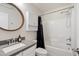Clean bathroom with a shower/tub combo and gray vanity at 2201 N Comanche Dr # 1075, Chandler, AZ 85224