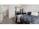 Bedroom with mirrored closet and floral bedding at 2201 N Comanche Dr # 1075, Chandler, AZ 85224