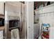 Stainless steel refrigerator, pantry, and laundry area in kitchen at 2201 N Comanche Dr # 1075, Chandler, AZ 85224
