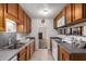 Functional kitchen with stainless steel sink, countertops, and wood cabinetry at 2315 W Butler Dr, Phoenix, AZ 85021