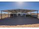 Enclosed metal horse stall provides shelter and protection with ample space, promoting the comfort and well-being of the animals at 2363 W Daniel Rd, Queen Creek, AZ 85144