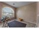 Spacious bedroom with an arched window and carpet flooring at 31637 W Grant St, Buckeye, AZ 85326