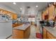 Kitchen with island, wood cabinets, and appliances at 31637 W Grant St, Buckeye, AZ 85326