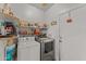 Functional laundry room, washer, dryer, and storage shelves at 31637 W Grant St, Buckeye, AZ 85326