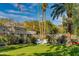 Expansive backyard featuring a lawn, desert landscaping, and seating area at 3601 N 55Th Pl, Phoenix, AZ 85018