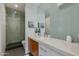 Modern bathroom with a glass-enclosed shower, sleek vanity, and eye-catching blue tile accent wall at 3601 N 55Th Pl, Phoenix, AZ 85018