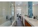 Spacious bathroom featuring double sinks, a tub with a shower, and modern finishes at 3601 N 55Th Pl, Phoenix, AZ 85018
