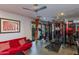 Brightly lit home gym featuring ample exercise equipment and a comfortable lounge area at 3601 N 55Th Pl, Phoenix, AZ 85018