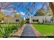 Stunning modern home with desert landscaping, manicured lawn, and blue skies at 3601 N 55Th Pl, Phoenix, AZ 85018