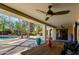 Relaxing covered patio with a large dining table overlooking a pristine pool and lush landscaping at 3601 N 55Th Pl, Phoenix, AZ 85018