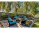 Cozy outdoor seating area with a fire pit, comfortable chairs, and lush landscaping for relaxing evenings at 3601 N 55Th Pl, Phoenix, AZ 85018