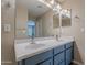 Modern double vanity bathroom with blue cabinets and updated faucets at 3647 W Thalia Ct, Phoenix, AZ 85086