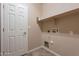 Laundry room with washer dryer hookups and storage shelves at 3647 W Thalia Ct, Phoenix, AZ 85086