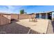 This low-maintenance gravel backyard features a block wall, shed, and covered patio, perfect for outdoor living at 3801 W Barnes Ln, Phoenix, AZ 85051