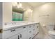 This bright bathroom features a double vanity with white cabinets and modern fixtures at 3801 W Barnes Ln, Phoenix, AZ 85051