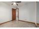 Bedroom with tile flooring and a natural wood door at 3801 W Barnes Ln, Phoenix, AZ 85051