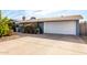 Ranch style home with attached garage, driveway, and landscaping at 3801 W Barnes Ln, Phoenix, AZ 85051