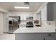 Bright kitchen with white cabinetry, stainless steel appliances, and quartz countertops at 3801 W Barnes Ln, Phoenix, AZ 85051