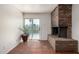 Living room with a red brick fireplace and access to the backyard pool at 3801 W Barnes Ln, Phoenix, AZ 85051