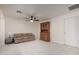 Spacious living room area with sofa and dark wood china hutch, bright and airy at 3801 W Barnes Ln, Phoenix, AZ 85051
