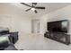 Open living space with large flat screen television and marble-look tiled floors at 3801 W Barnes Ln, Phoenix, AZ 85051