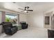 Bright living room features white tile floors, a ceiling fan and 2 plush recliners at 3801 W Barnes Ln, Phoenix, AZ 85051