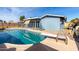 This outdoor pool features a diving board, a patio, and a blue house at 3801 W Barnes Ln, Phoenix, AZ 85051
