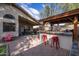 Outdoor kitchen, covered patio, and red chairs at 3947 E Potter Dr, Phoenix, AZ 85050