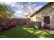 Artificial turf, red chairs, and a small built-in bar at 3947 E Potter Dr, Phoenix, AZ 85050