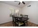 Dining area with dark wood table and four chairs, wood floors and window with shutters at 3947 E Potter Dr, Phoenix, AZ 85050