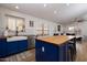 Modern kitchen with blue cabinets, butcher block island, and farmhouse sink at 3947 E Potter Dr, Phoenix, AZ 85050